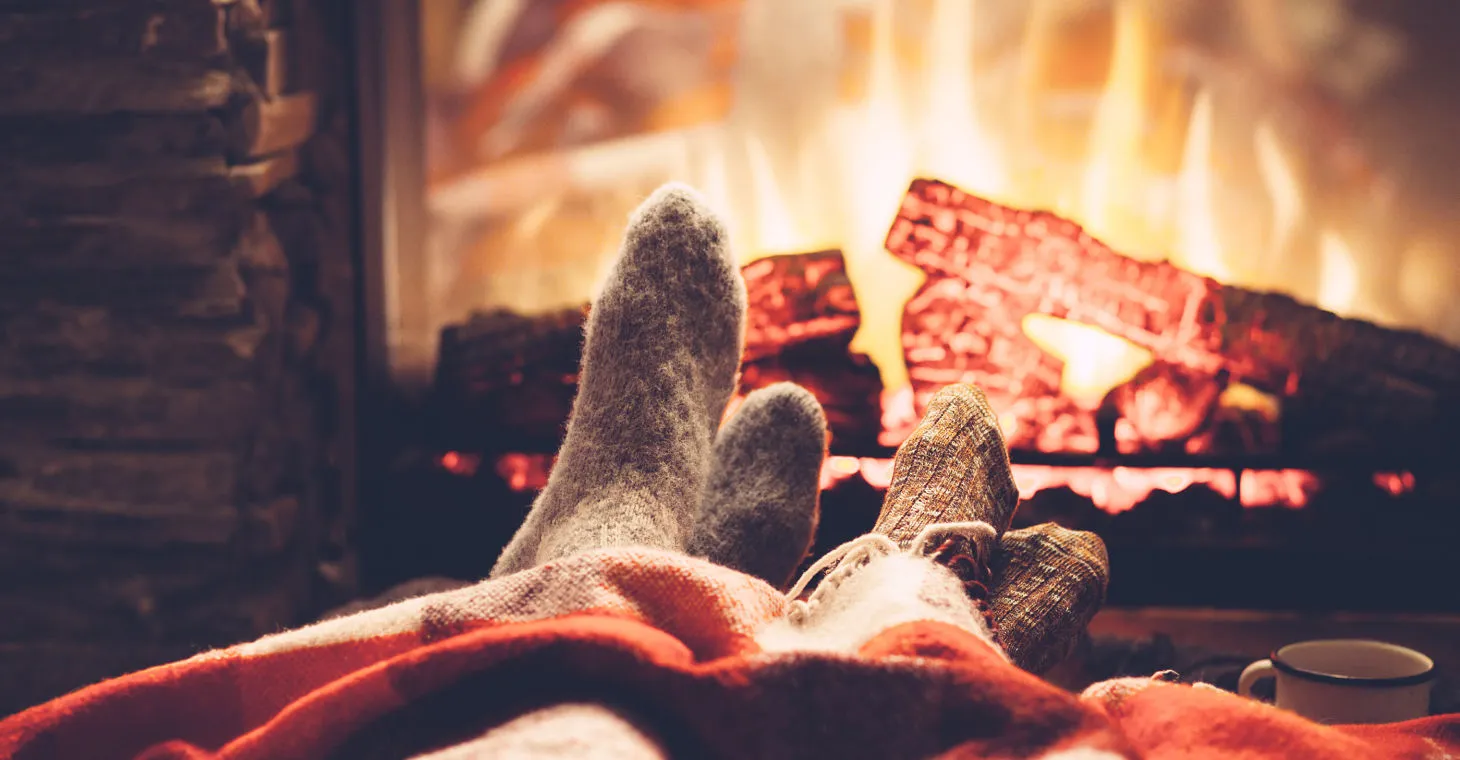 a couple by the fireplace on a winter getaway in Cedarburg, WI