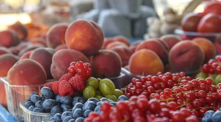 baskets of fruit at a farmers market stall