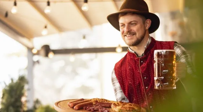 Man in traditional Bavarian outfit celebrating Pommerntag.