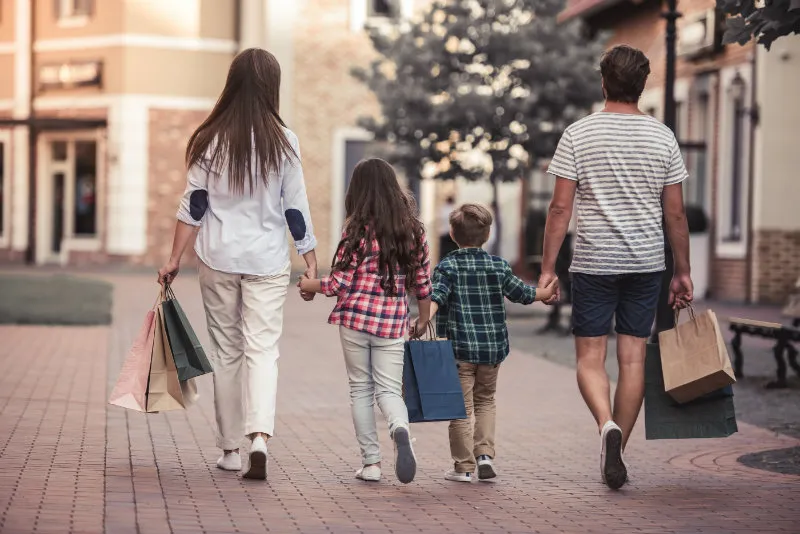 Family walking with shopping bags to the Cedarburg Cultural Center