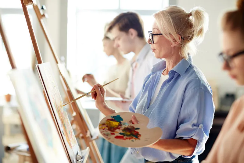 Woman painting and enjoying the arts at the Cedarburg Cultural Center