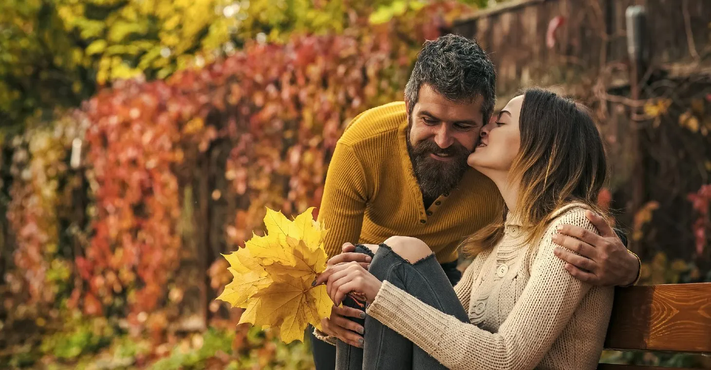woman kissing man's cheek on a Wisconsin fall getaway