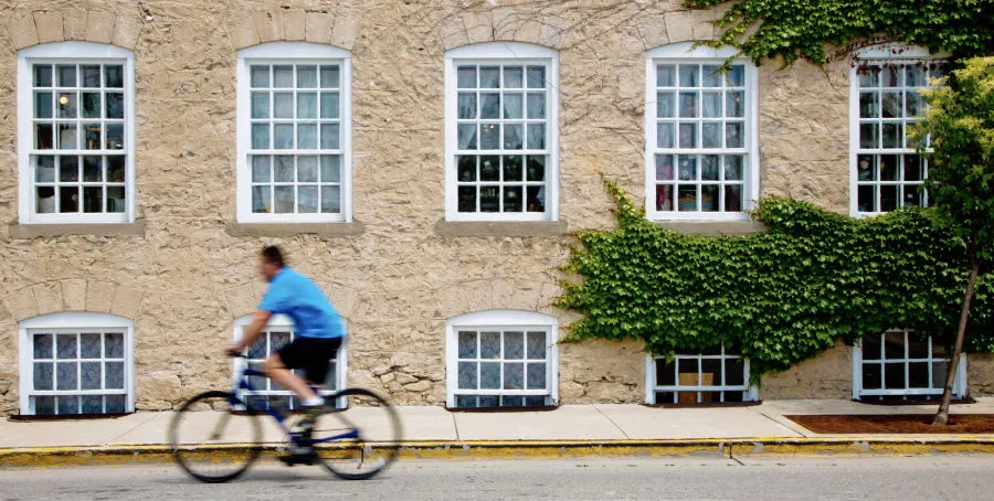 Ozaukee Interurban Trail - man biking past a building
