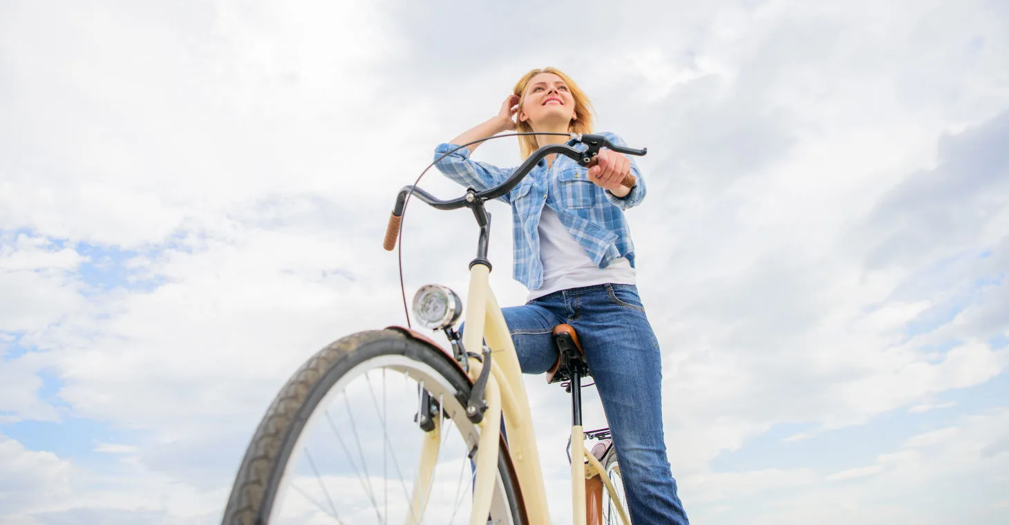Top Bike Trails in Cedarburg - A girl on a bike with clouds in the background