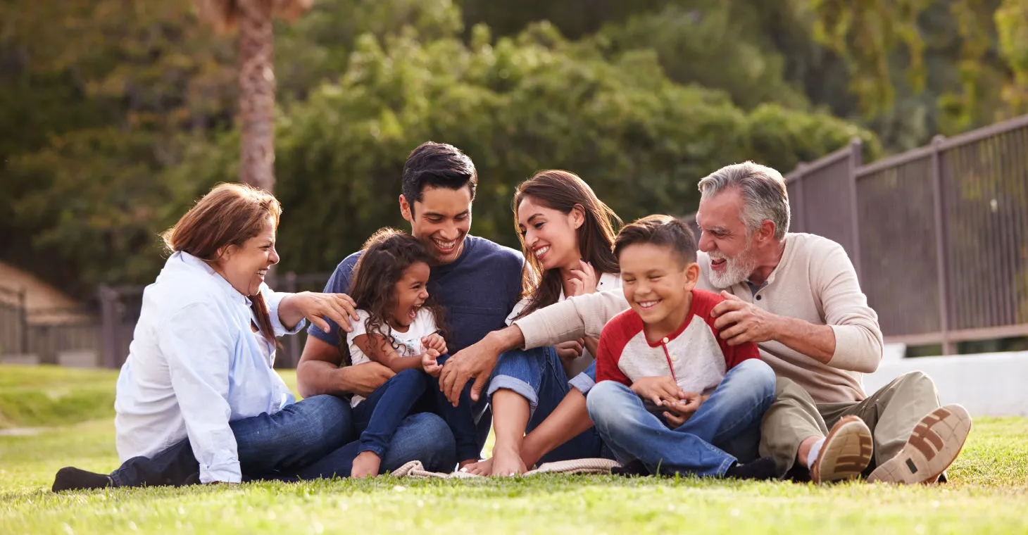 a family having fun on the grass in a park