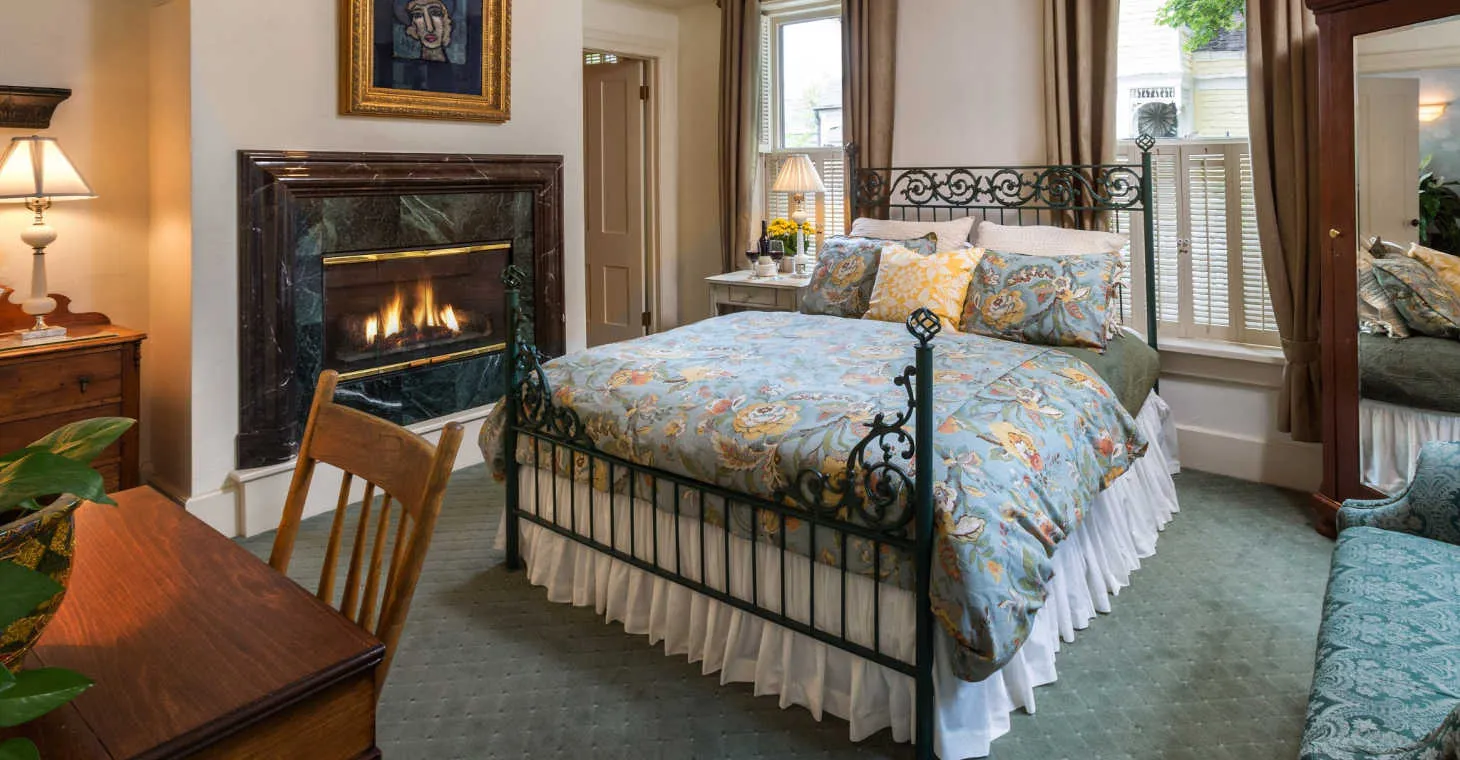A Washington House Inn room with a bed and fireplace