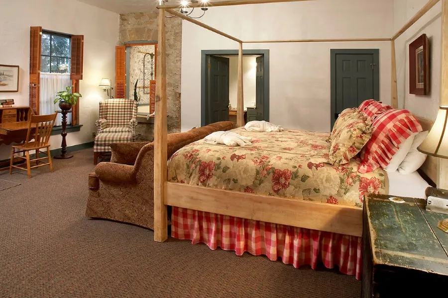 EDWARD BLANK room with four posted bed and corner chair