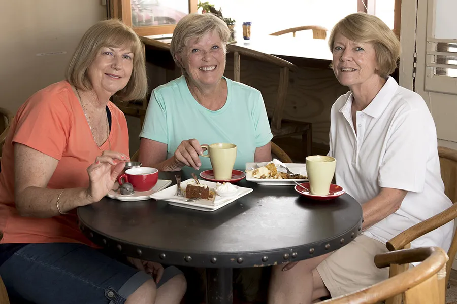 Three ladies having coffee and pastries at a cafe