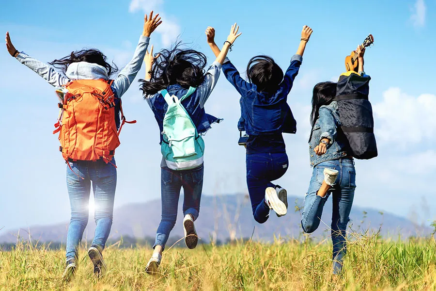 Girlfriends cheering at the end of a hike
