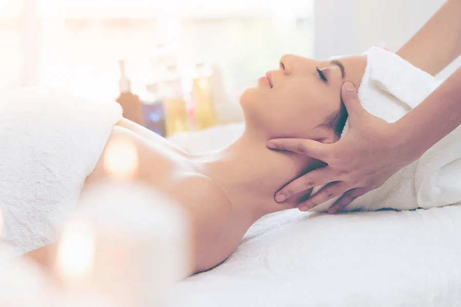 Woman getting a head massage during a spa getaway in Wisconsin 