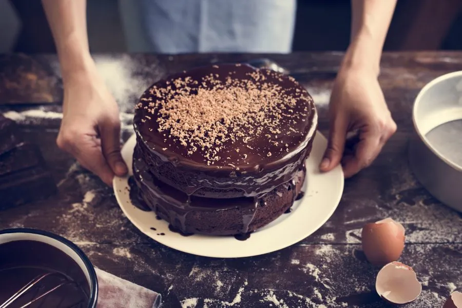 a woman making a chocolate cake