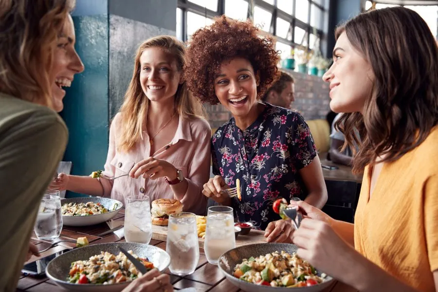 four friends having dinner at a restaurant