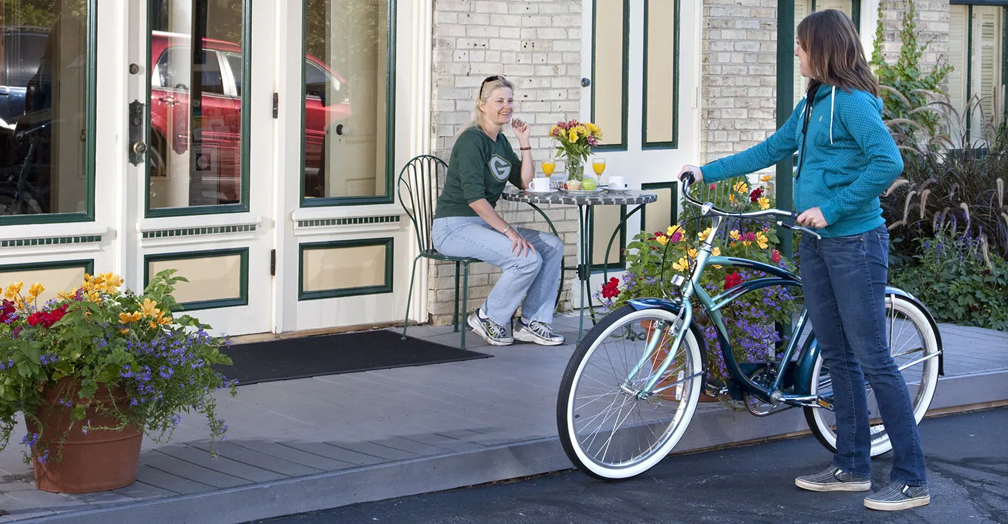 a woman with a bike outside the inn