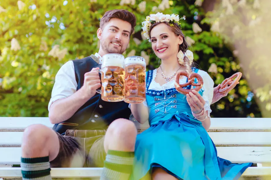 couple at Cedarburg Oktoberfest on a bench with beers