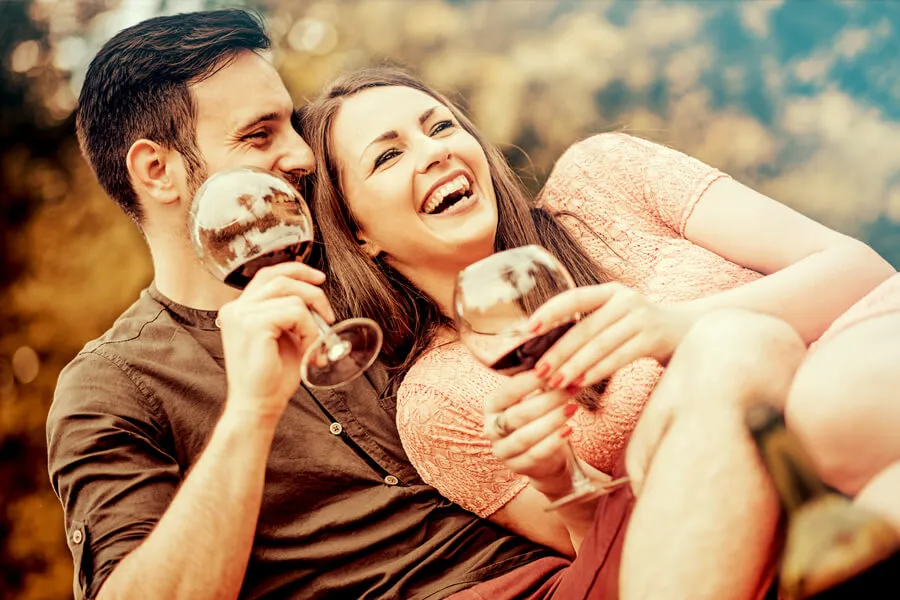 couple smiling with wine glasses at Cedarburg Harvest Festival