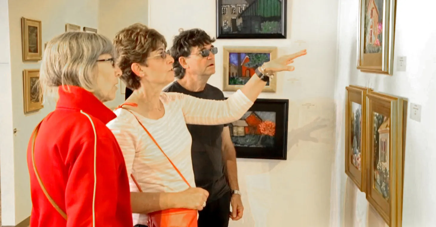 a group of people looking at art in Cedarburg