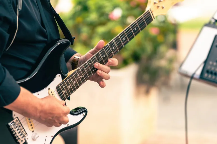 a man playing a guitar at an outdoor music festival in Cedarburg, Wisconsin
