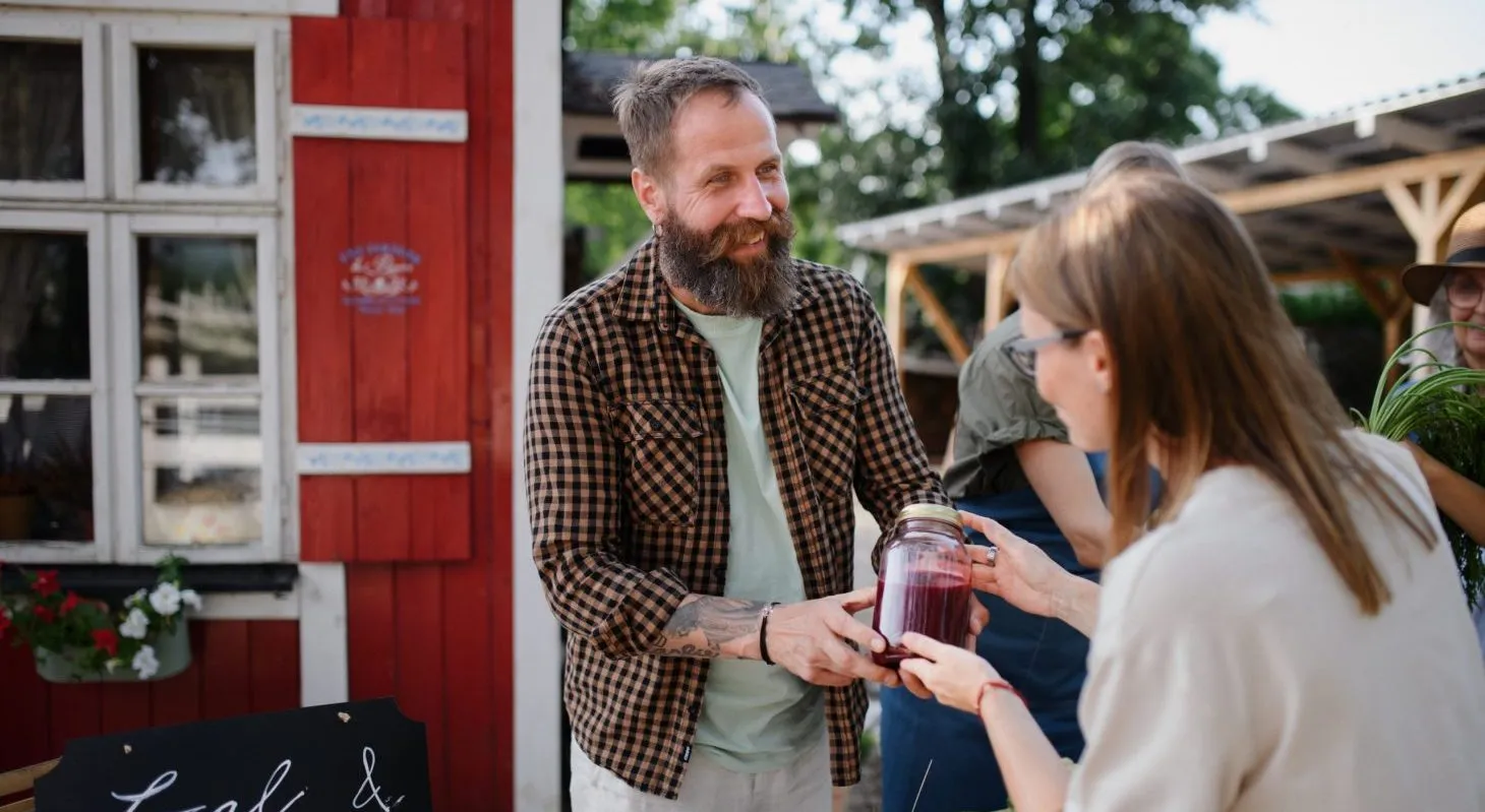 a woman buying a candle at a farmers market in Cedarburg
