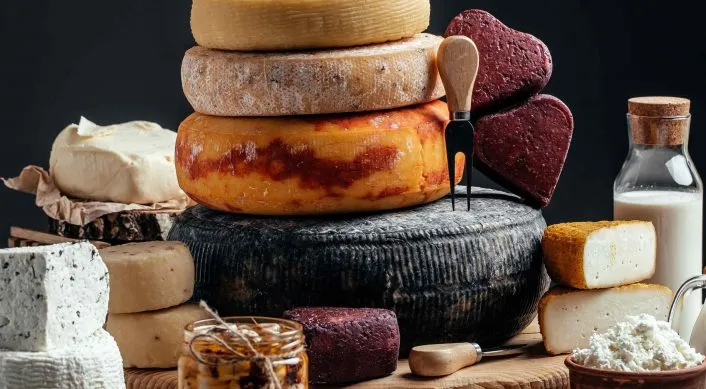 Stack of various cheese wheels from the Wisconsin Cheese Trail