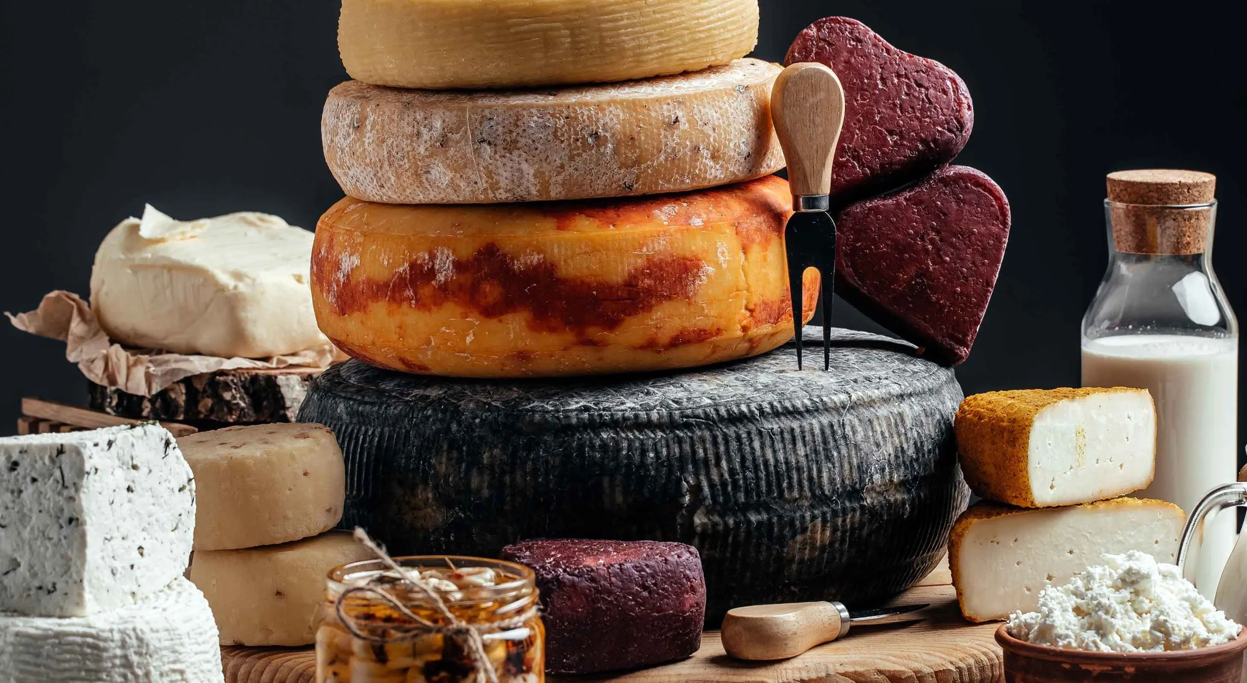 Stack of various cheese wheels from the Wisconsin Cheese Trail