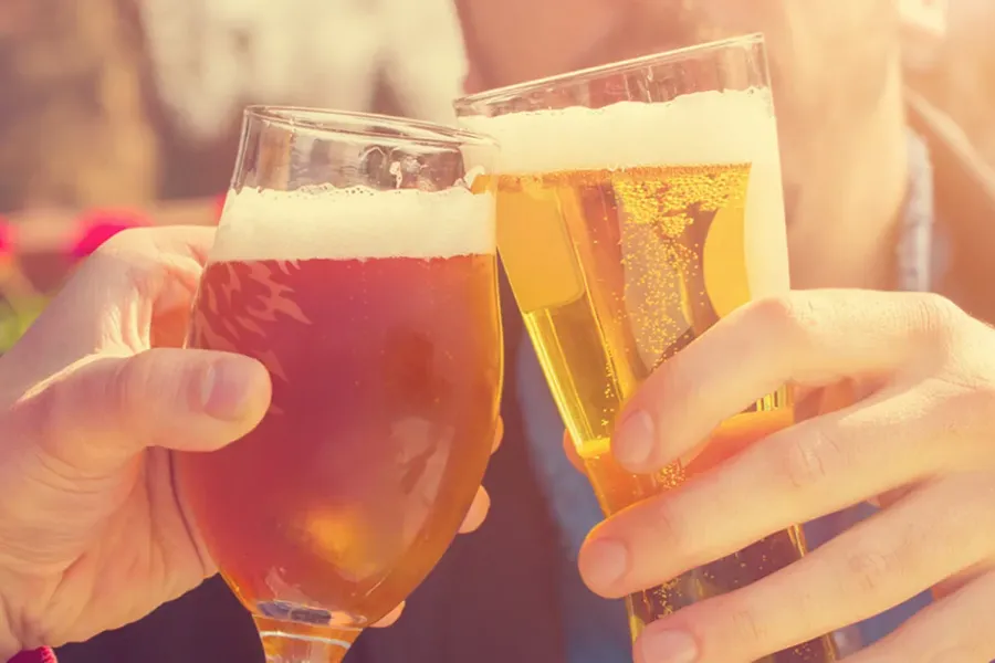 a couple with glasses of beer at a Cedarburg brewery