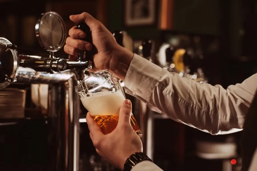 a man pouring a beer at a brewery in Cedarburg, WI