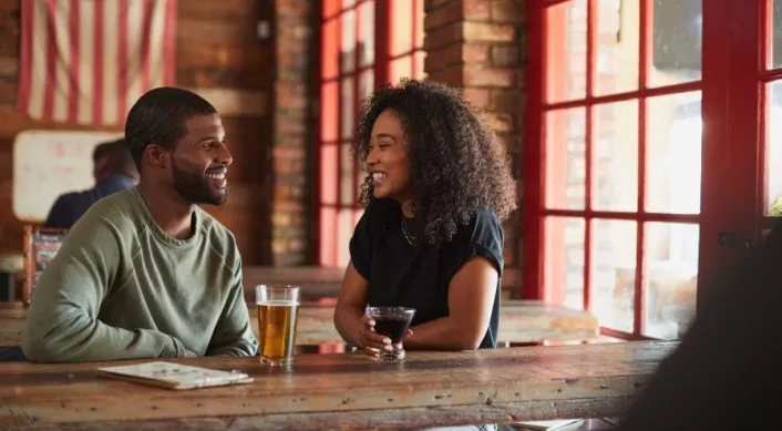 a young couple drinking beer near washington house inn