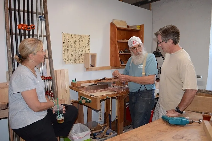 artist describing techniques to couple on Covered Bridge Art Tour in Cedarburg