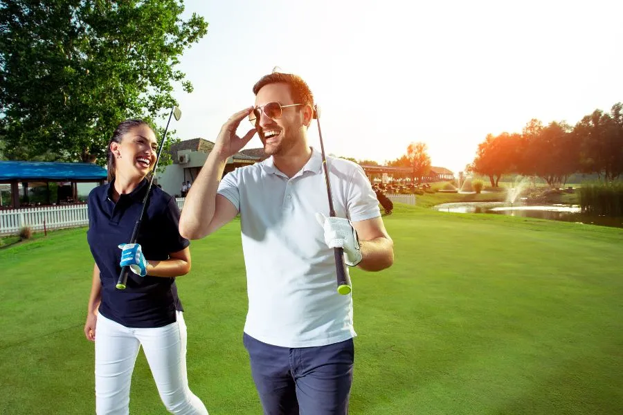 couple smiling and laughing on golf course