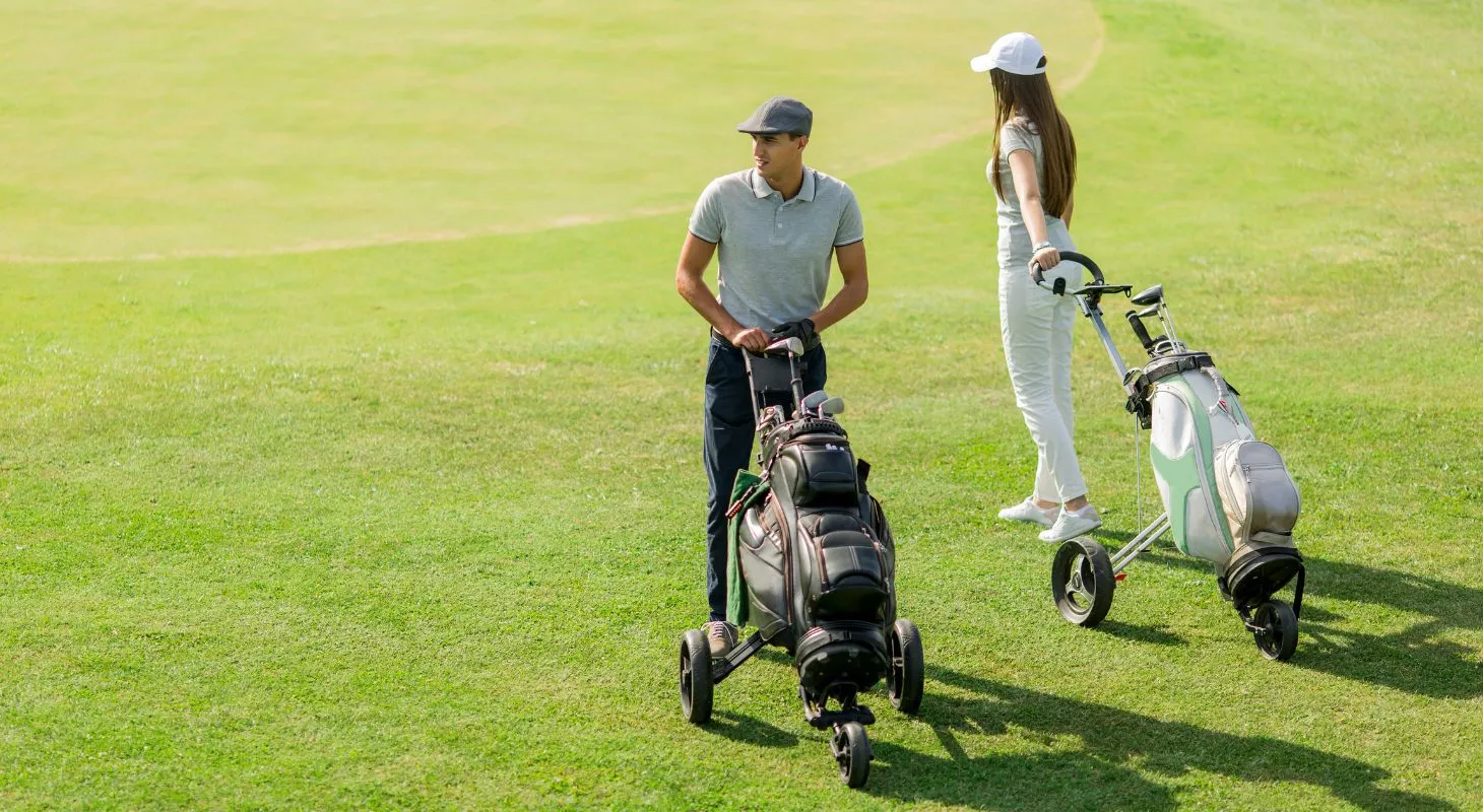 couple with golf caddies