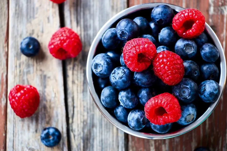 Bowl of mixed berries on a rustic wood surface