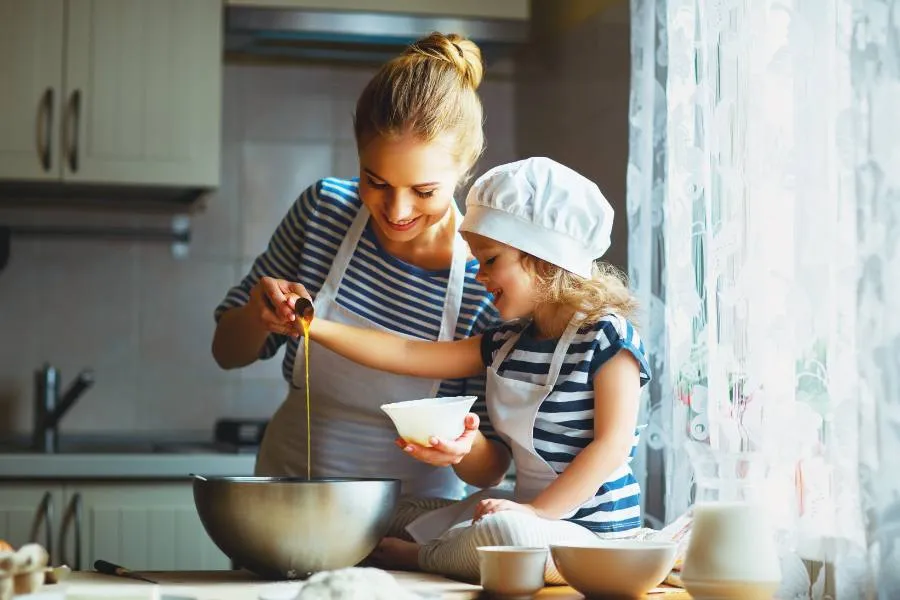 Woman and her child baking together in a kitchen