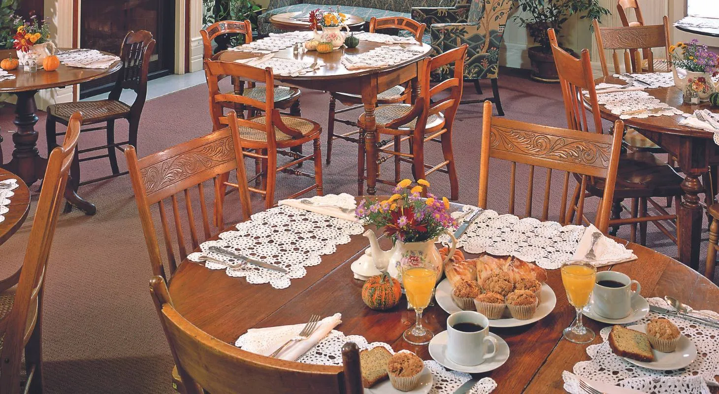 Breakfast room at the Washington House Inn with baked goods and orange juice on the tables.