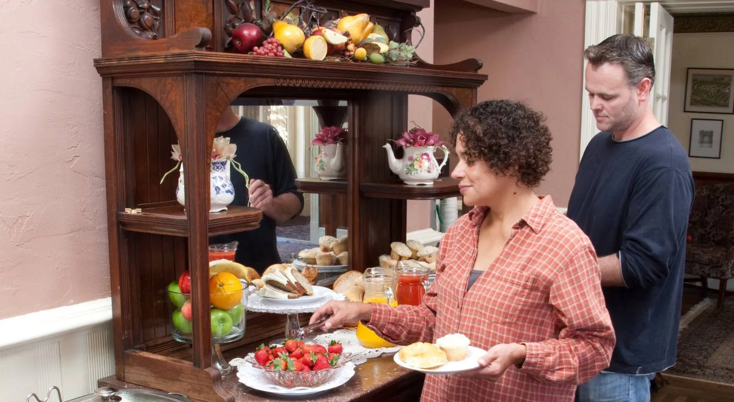 Woman selecting breakfast food at a buffet at Washington House Inn
