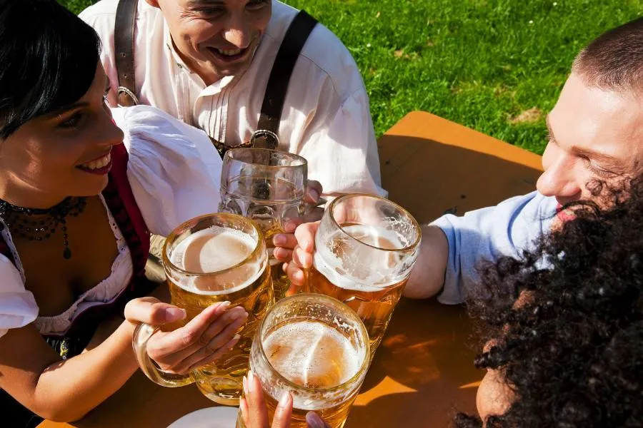 Group of friends drinking beer in traditional German clothes at Cedarburg Oktoberfest