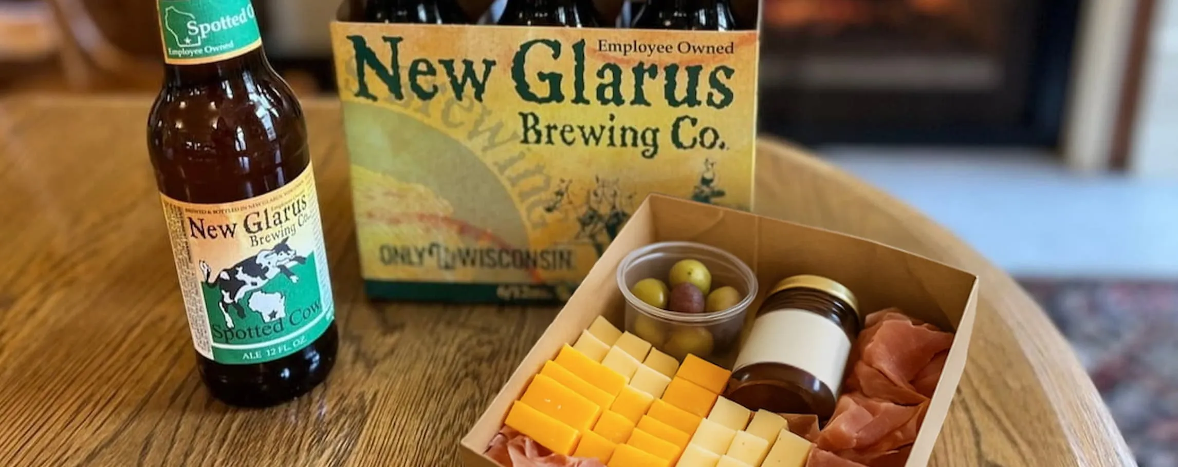 six pack of beer with small charcuterie box