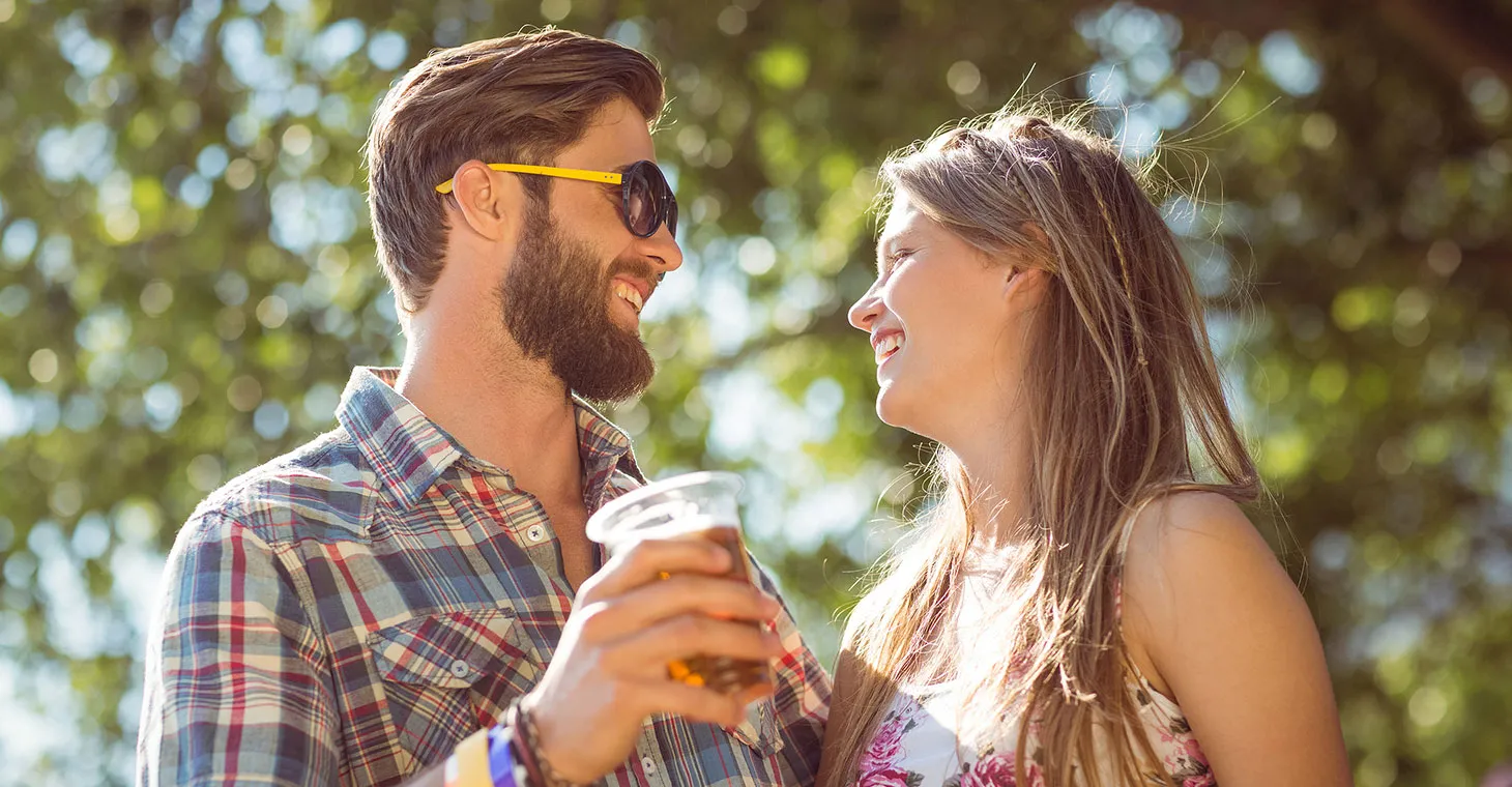 Couple enjoying beer outside at an event