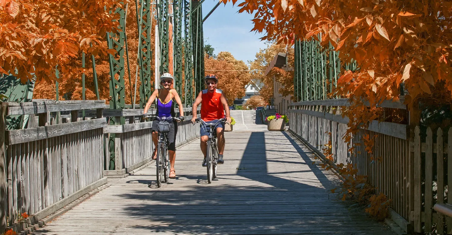 a couple riding bikes in fall in Cedarburg