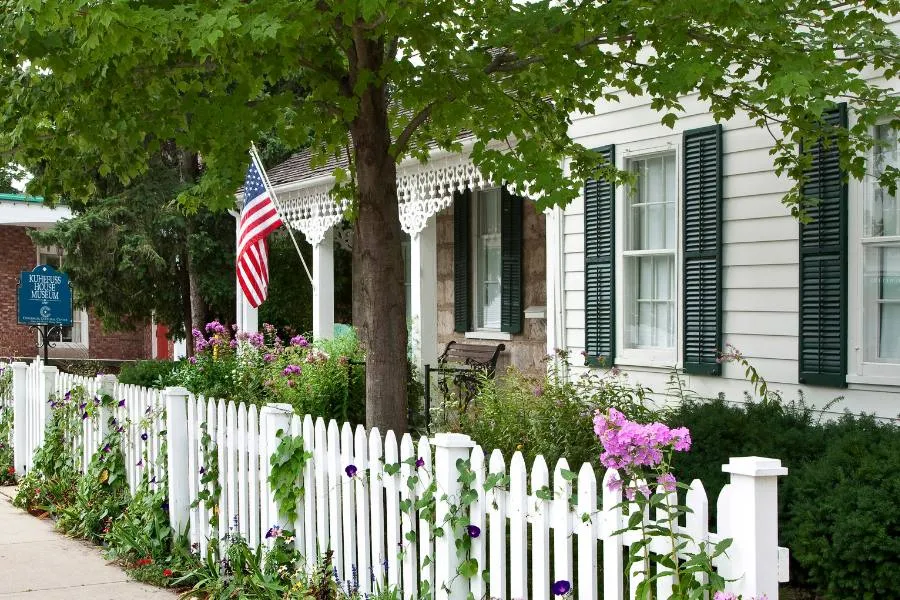 Pretty white picket fence outside historic building in Cedarburg