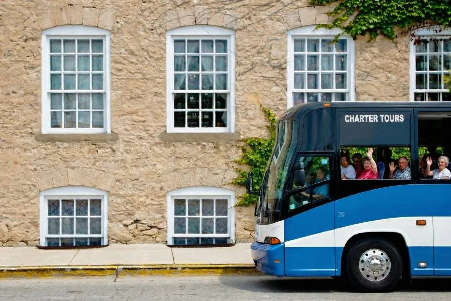 Charter bus tour driving down the road in Cedarburg