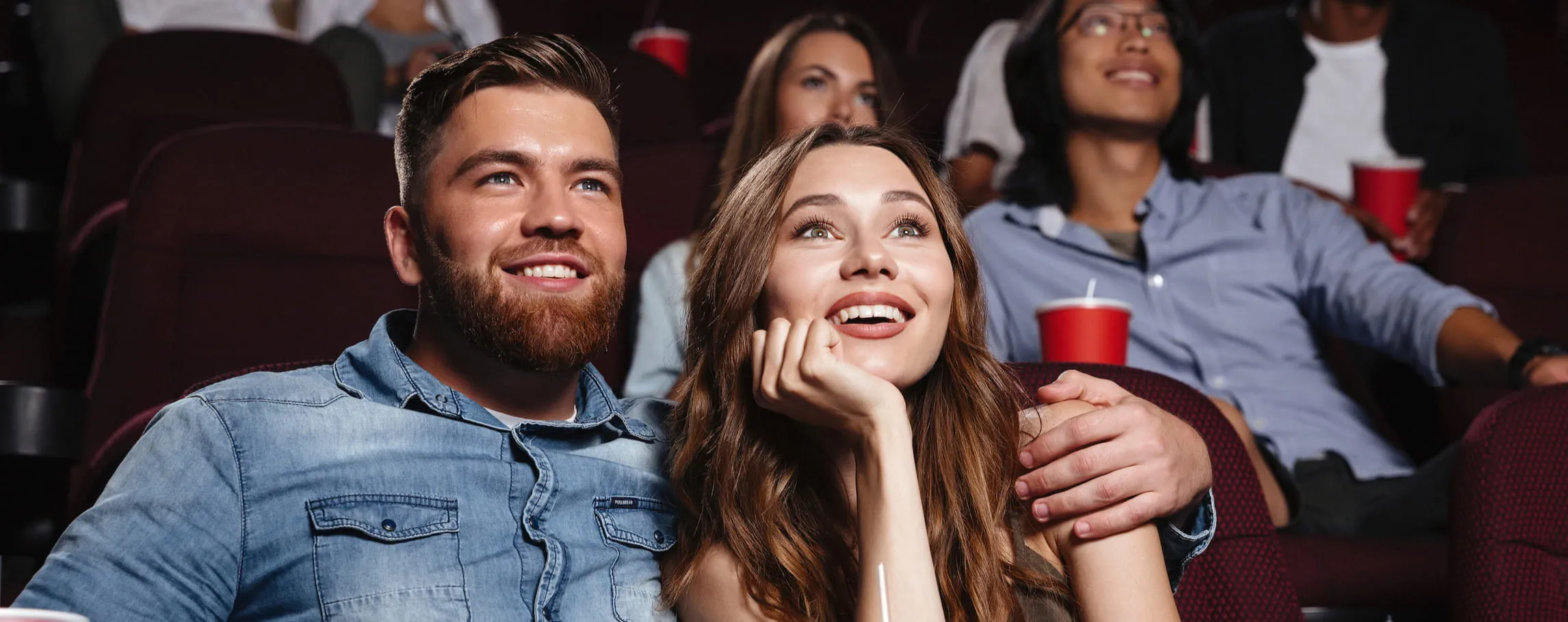 young couple sitting in the movie theater